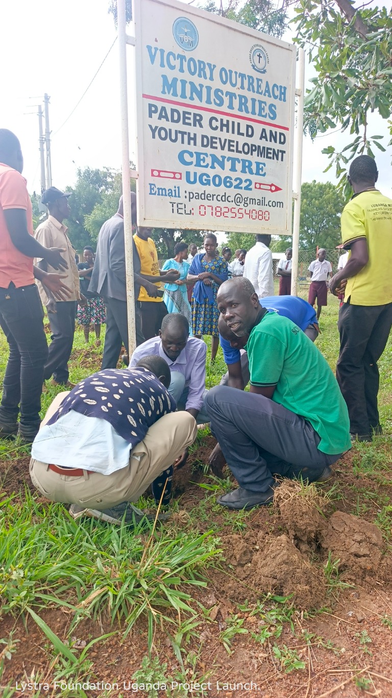 Community members plant a young tree as part of a local restoration initiative